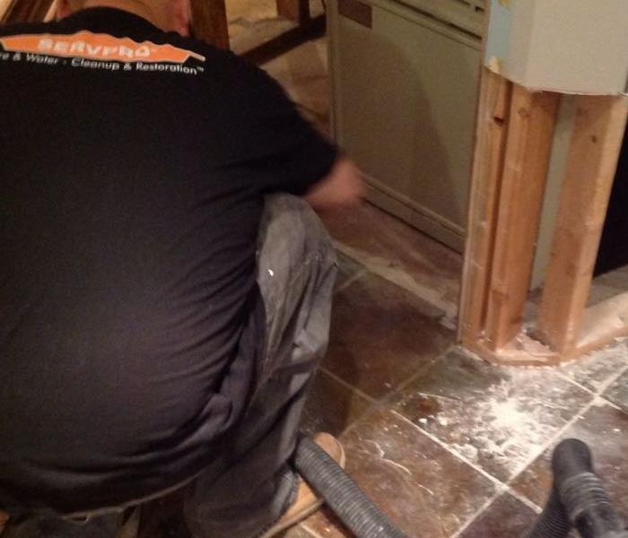 SERVPRO team member in action creating flood cuts in wall.