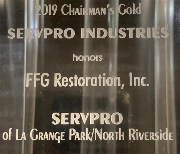 A glass award plaque with Chairman’s Gold Award for SERVPRO of La Grange Park/North Riverside written on it.