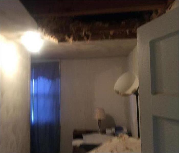 Big hole on ceiling due to storm damage