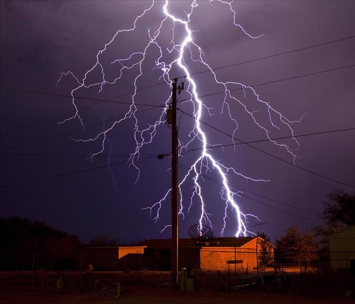 lightning bolt behind electric utility pole